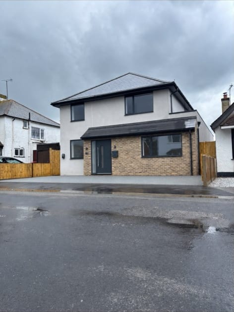 Silicone rendered detached new-build house with brick plinth in Kent